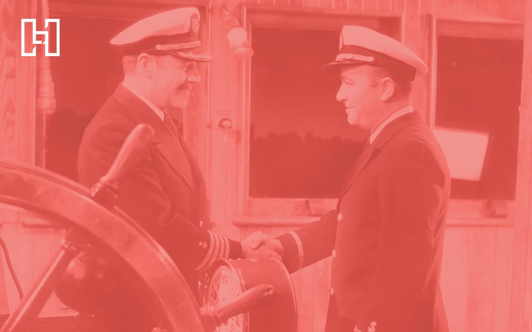 Two captains shaking hands, red overlay on photo